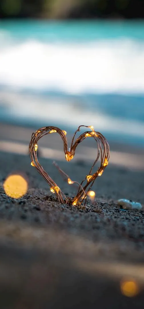 Corazón de luces sobre la arena de la playa